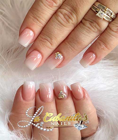 Cute pink and white ombre short square nails with rhinestones on accent nail