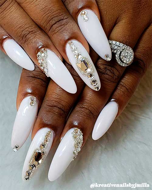 Cute white almond nails for dark skin hands adorned with some rhinestones - Bling almond shaped nails