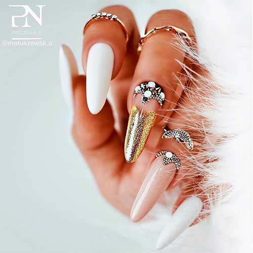 Matte white almond nails with gold with rhinestones and two accent gold glitter and nude color nails Matte white almond nails with gold with rhinestones and two accent gold glitter and nude color nails