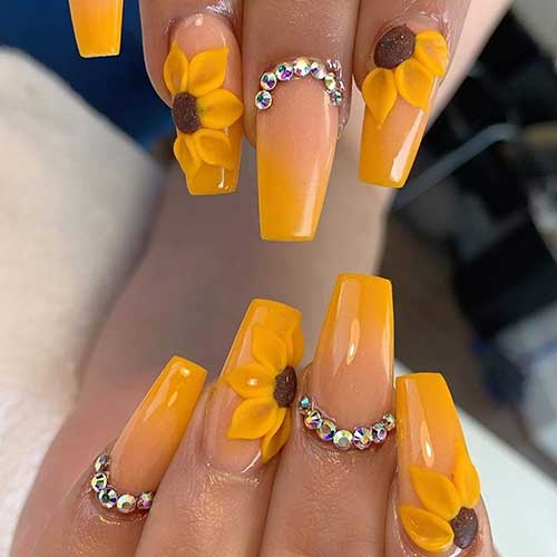 Coffin shaped mustard yellow ombre nails with sunflower and rhinestones design Coffin shaped mustard yellow ombre nails with sunflower and rhinestones design