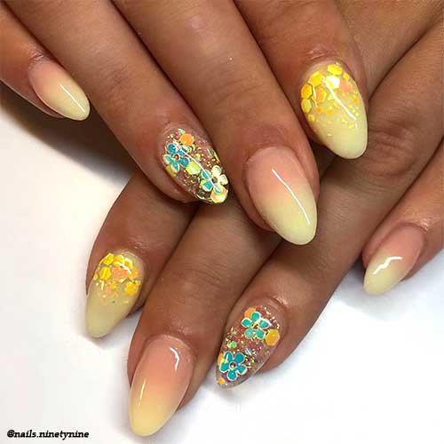 Cute almond pastel yellow ombre nails with accent floral clear nail adorned with glitter