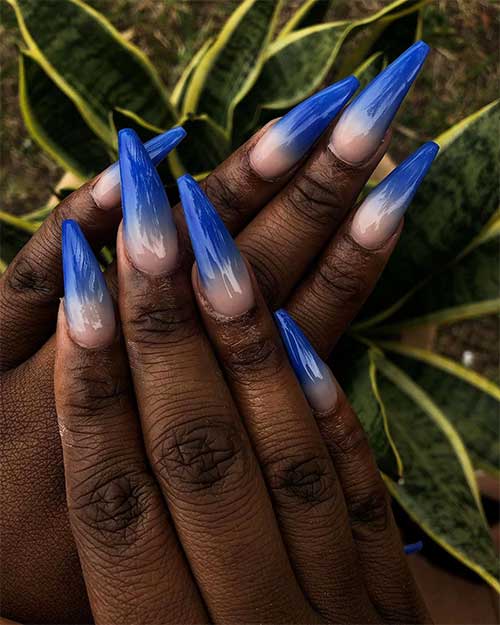 Cute royal blue ombre nails coffin shaped on dark skin hands Cute royal blue ombre nails coffin shaped on dark skin hands