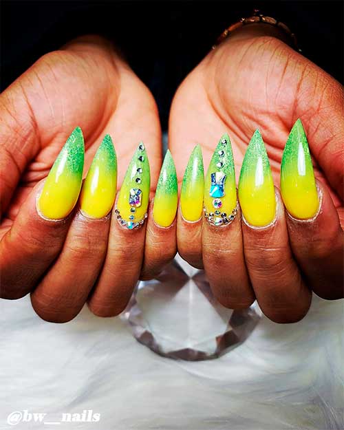 Lime green and yellow ombre nails stiletto shaped long with rhinestones on accent nail