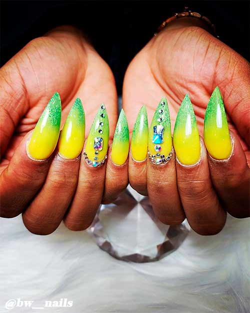 Lime green and yellow ombre nails stiletto shaped long with rhinestones on accent nail Lime green and yellow ombre nails stiletto shaped long with rhinestones on accent nail
