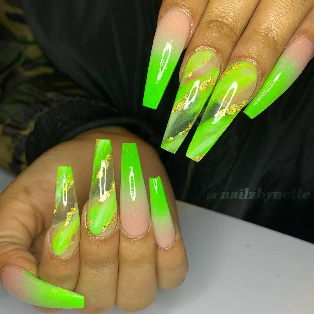 Lime green ombre coffin nails with two accent lime green marble nails adorned with gold foil