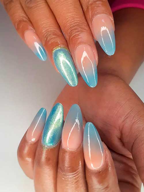 Long almond-shaped ice blue ombre nails 2023 with metallic ice blue an accent nail