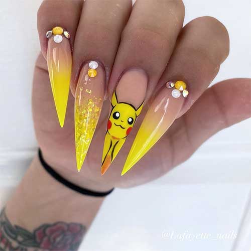 Yellow ombre stiletto nails 2020 with rhinestones, accent glitter nail, and second accent hand painted nail design