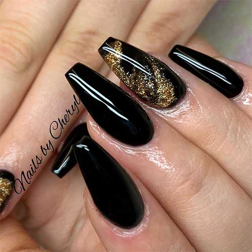 Cute black coffin nails with gold glitter on accent nail design