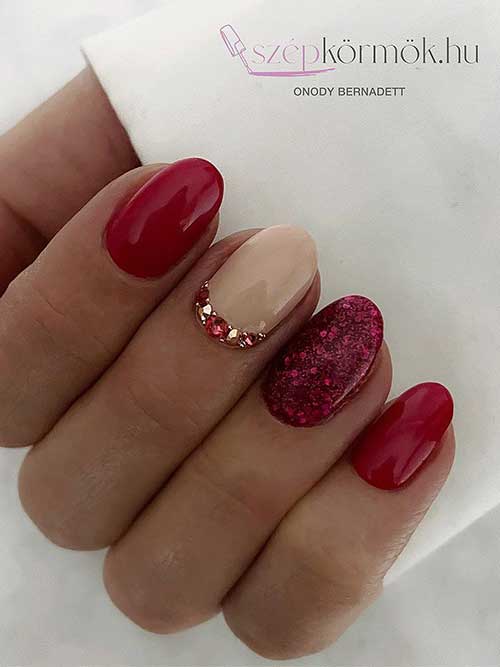 Short Red Nails with Glitter, Rhinestones, and A Nude Accent Nail That Suit Valentine's Day