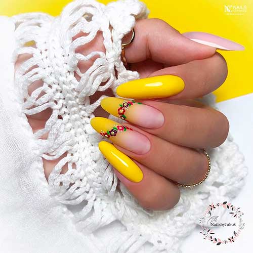 Long almond yellow nails 2021 with flowers on two accent yellow ombre nails besides pink thumb nail!