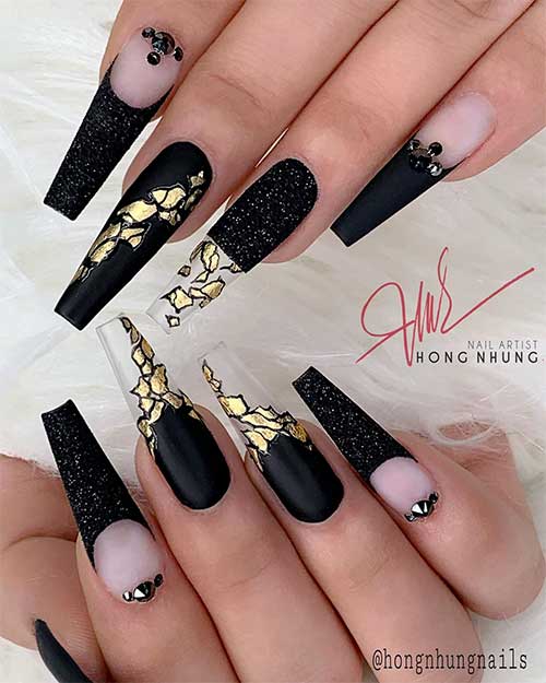 Matte black coffin nails with gold and two accent black glitter coffin nails with rhinestones