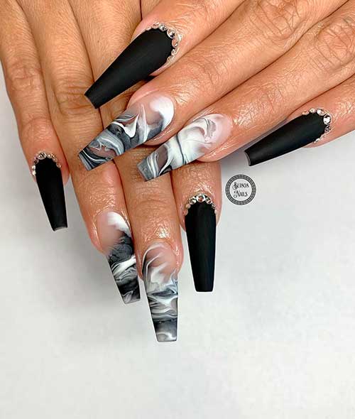 Matte black coffin nails with rhinestones blended with two accent white and black marble nails!