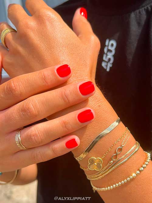 Short Red Nails with Gold Jewelry