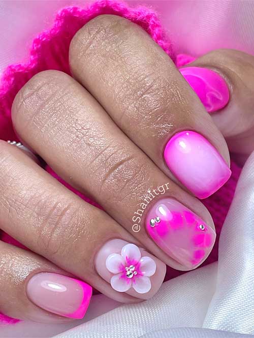 Short pink nails with a soft gradient, hot pink tips, 3D floral accents, and rhinestones for a playful, elegant look. Short pink nails with a soft gradient, hot pink tips, 3D floral accents, and rhinestones for a playful, elegant look.
