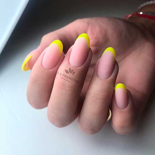 Cute almond shaped matte neon yellow French tip nails idea!