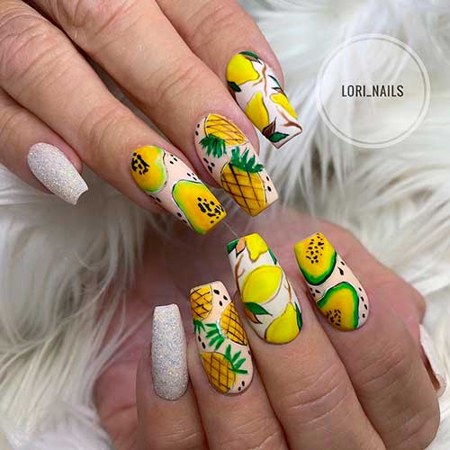 Cute fruit nails art is the blend of papaya and cute pineapple nails with two accent glitter and lemon nails.