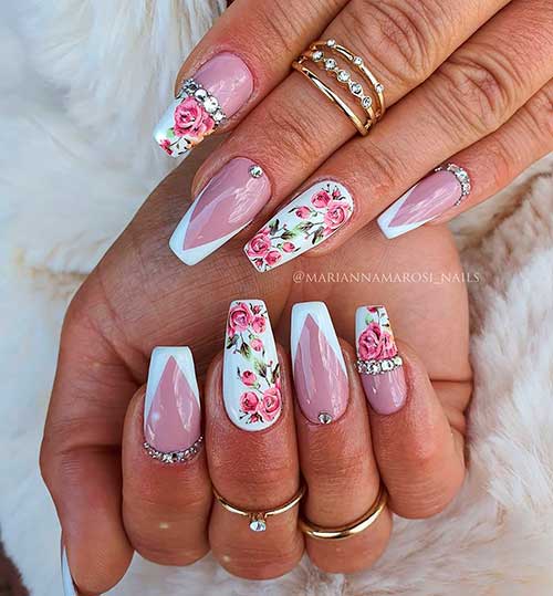 Cute white V French tip coffin nails with two floral print accent nails and rhinestones!