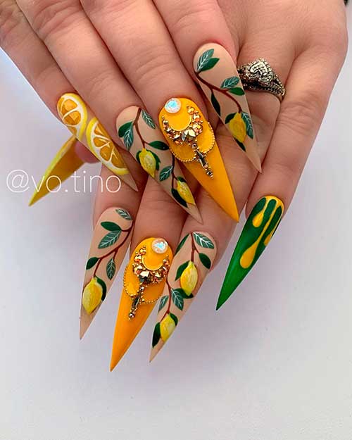 One of the best stiletto fruit nails that consists of stiletto lemon nails with accent stiletto mustard nail adorned with gold rhinestones!