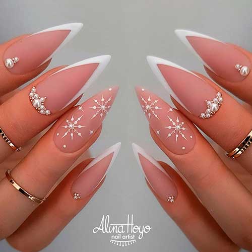 White Matte Stiletto V Tip Nails with Rhinestones and Snowflakes on An Accent