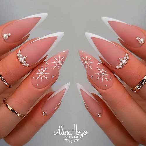White Matte Stiletto V Tip Nails White Matte Stiletto V Tip Nails with Rhinestones and Snowflakes on An Accent