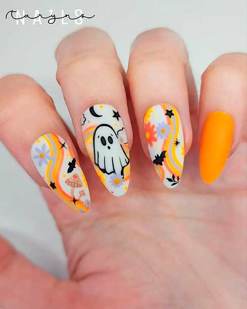 Cute orange Halloween almond nails feature bats, ghosts, flowers, and swirls