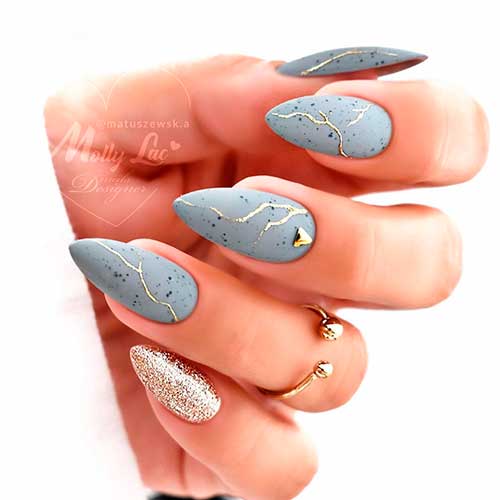 Cute almond matte grey nails with gold glitter and rhinestones Cute almond matte grey nails 2021 with black dots, gold glitter and rhinestones