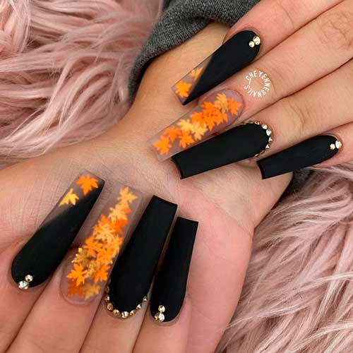 Cute long black fall nails coffin shaped with maple leaf on nails and some rhinestones!