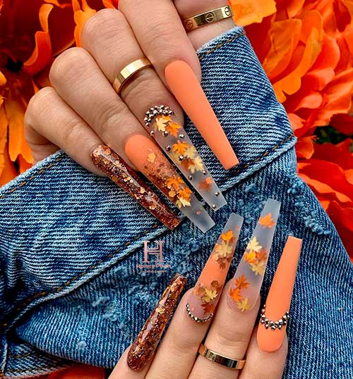 Cute long fall nails coffin shaped with autumn leaves on nails, glitter accent nail, and accent matte orange nail