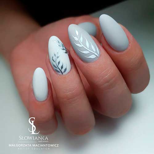 Cute two different almond shaped matte grey nails 2020 shades design with two accent grey leaf nails