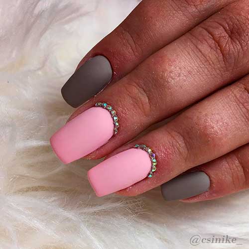 Dark matte grey nails with matte pink nails adorned with rhinestones design!