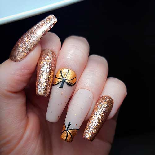 Halloween coffin shaped sparkle nails 2020 with two accent pumpkin nails with little gold glitter design - Halloween Nail Ideas