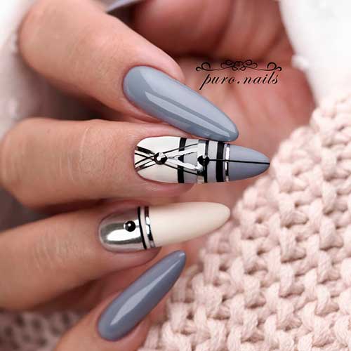 Long grey nails 2020 almond shaped with some black lines, silver strips and black rhinestones on two accent nails!