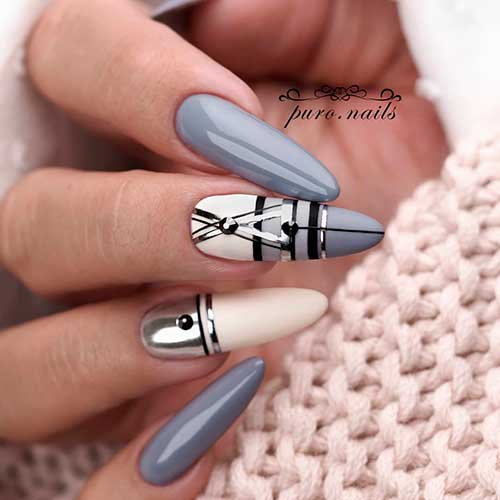 Long grey nails 2020 almond shaped with some black lines, silver strips and black rhinestones on two accent nails! Long grey nails 2020 almond shaped with some black lines, silver strips and black rhinestones on two accent nails!