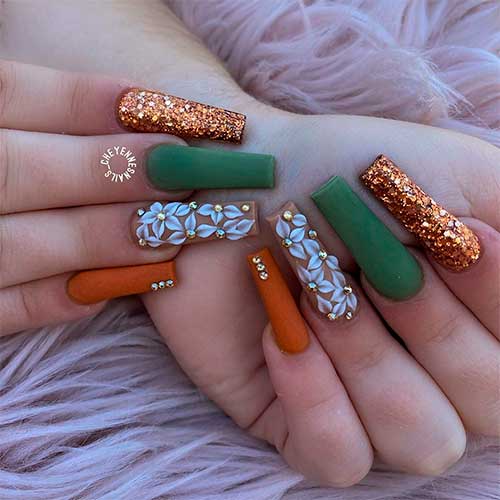 Long squared fall nails consist of gold glitter, burnt orange, nude, and matte olive green nails!