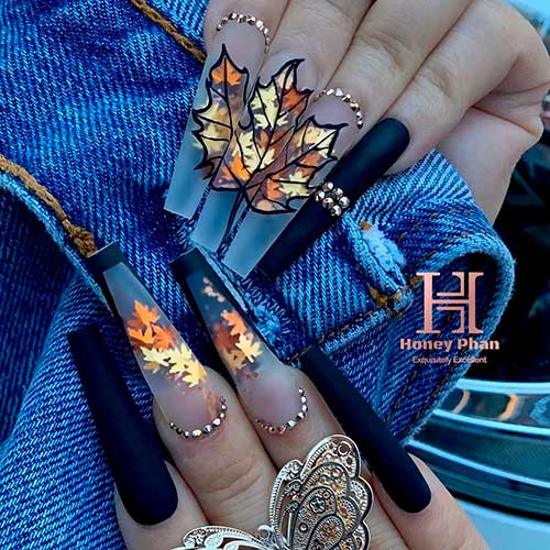 Matte black nails with maple leaves over the long clear nails coffin shaped and adorned with rhinestones for fall 2020! Matte black nails with maple leaves over the long clear nails coffin shaped and adorned with rhinestones for fall 2020!