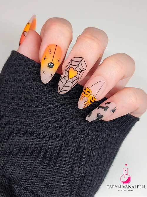 Nude Halloween Nail Design Nude Halloween nails almond shape that features spider webs, pumpkins, bones, spiders, and two orange ombre accent nails