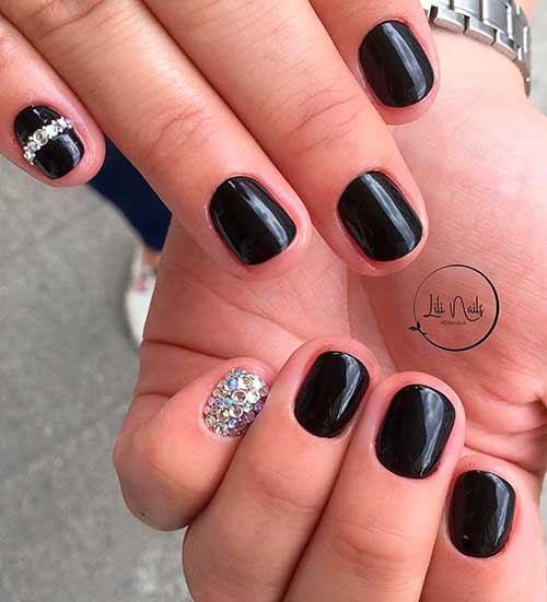 Short black gel nails 2020 with silver rhinestones on accent nail idea