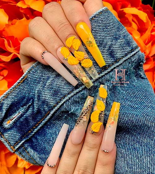 fancy fall nails with 3D mustard yellow fall leaves on clear nail tips coffin shaped with encapsulated autumn glitter!