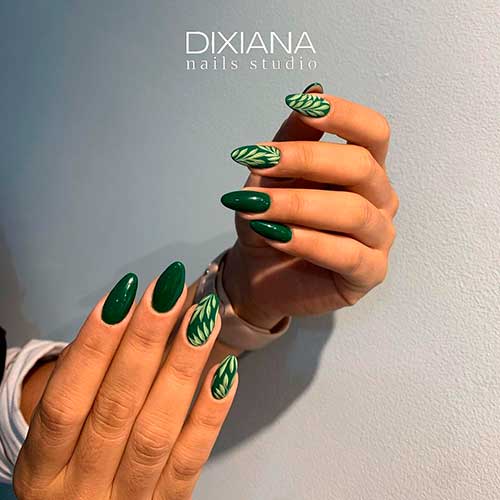 Almond dark green nails with leaf art design for a unique look!