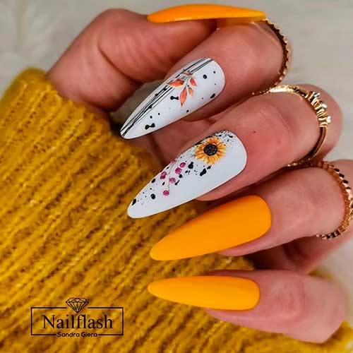 Autumn matte yellow nails 2020 almond shaped with two accent white nails adorned with sunflower and black stripes - autumn yellow nail designs