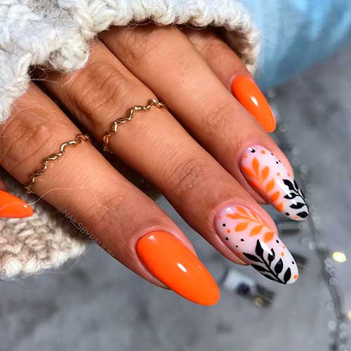 Classy orange nails 2020 set black and orange leaves with some dots over two accent white sheer nails for autumn 2020