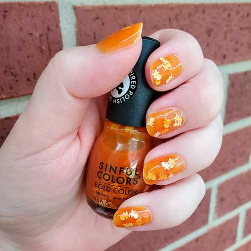 Cute Halloween nails with glitter which, swiped with Sinful Colors Twisted Toffee Halloween Nail Polish!
