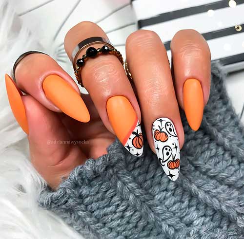 Cute Pumpkin Matte Orange Nails Idea with sticker-ed pumpkins and ghosts over two accent nails for Halloween 2020!