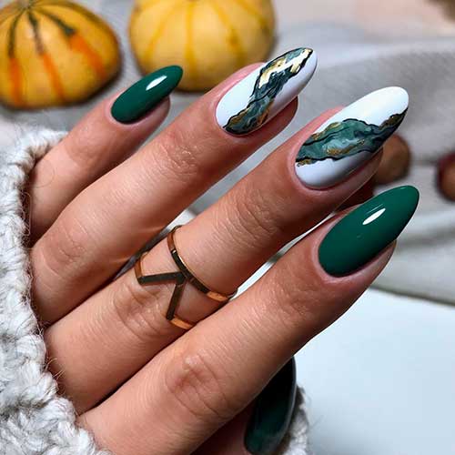 Cute almond shaped dark green nails with two accent white nails with hand painted autumn look! Cute almond shaped dark green nails with two accent white nails with hand painted autumn look!