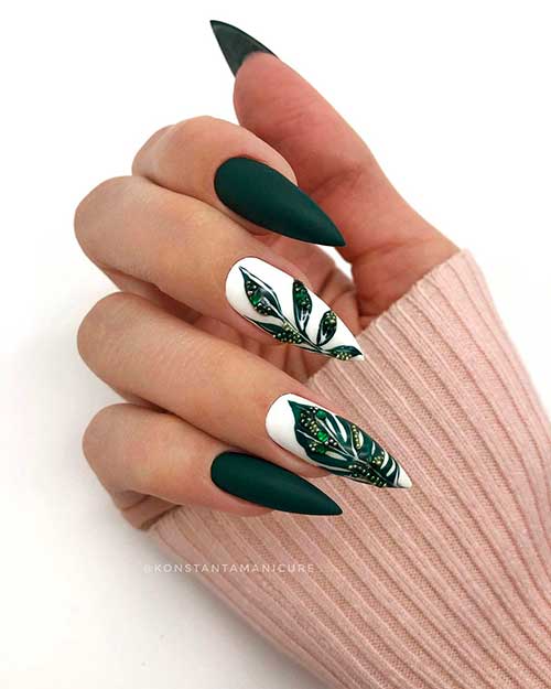 Cute stiletto shaped dark green nails 2020 design with dark green autumn leaves over white nails! Cute stiletto shaped dark green nails 2020 design with dark green autumn leaves over white nails!