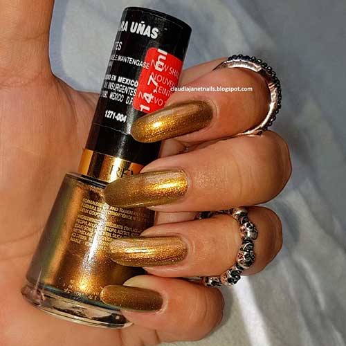 Top nails manicured with glossy holographic green-yellow Revlon chameleon super lustrous nail enamel nail polish