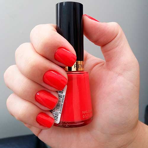 Top nails manicured with red-orange Revlon Fearless super lustrous nail enamel nail polish