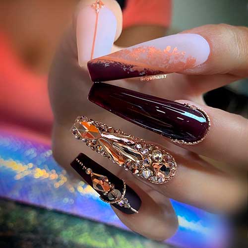 Cute nail art design which, consists of matte nude pink, and burgundy nails and two accent bling nails 2020 design! Cute nail art design which, consists of matte nude pink, and burgundy nails and two accent bling nails 2020 design!