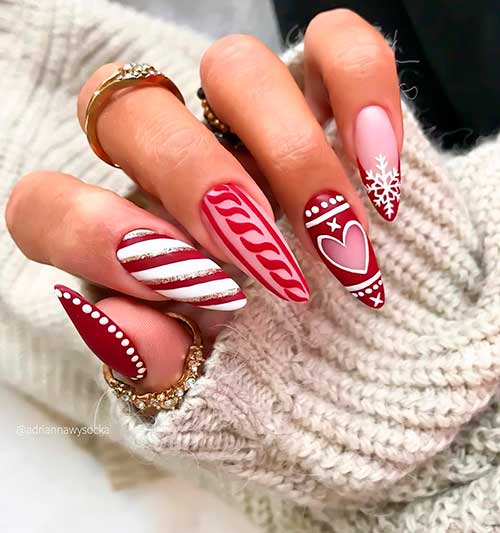 Cute almond shaped pink and red Christmas nails 2020 with two accent candy cane and snowflake nails idea for celebration!