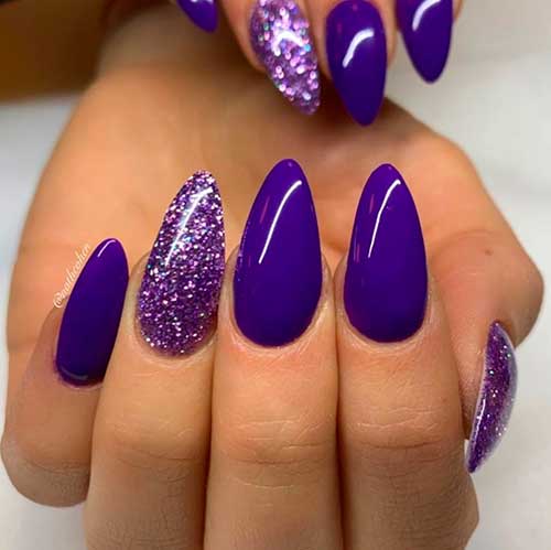 Cute dark purple nails almond shaped with purple glitter nail polish on accent nail design!